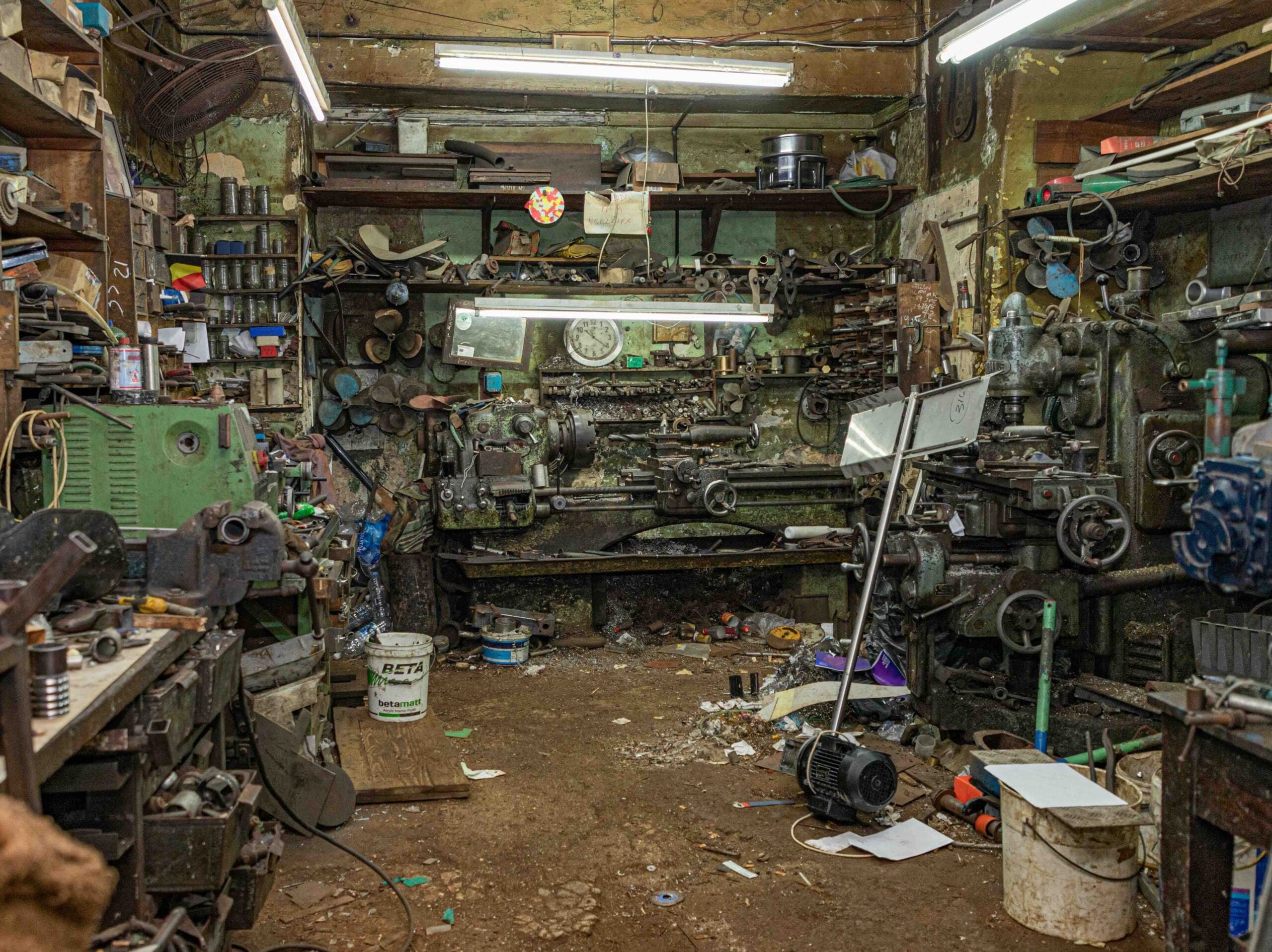 A photo of a small, cluttered garage in need of a clean out.