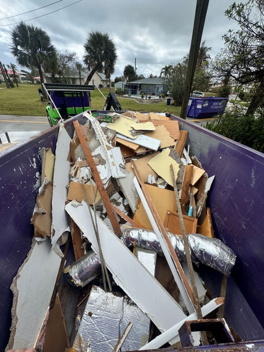 20 yard dumpster filled with drywall and renovation debris during a home remodel in Port St Lucie Florida